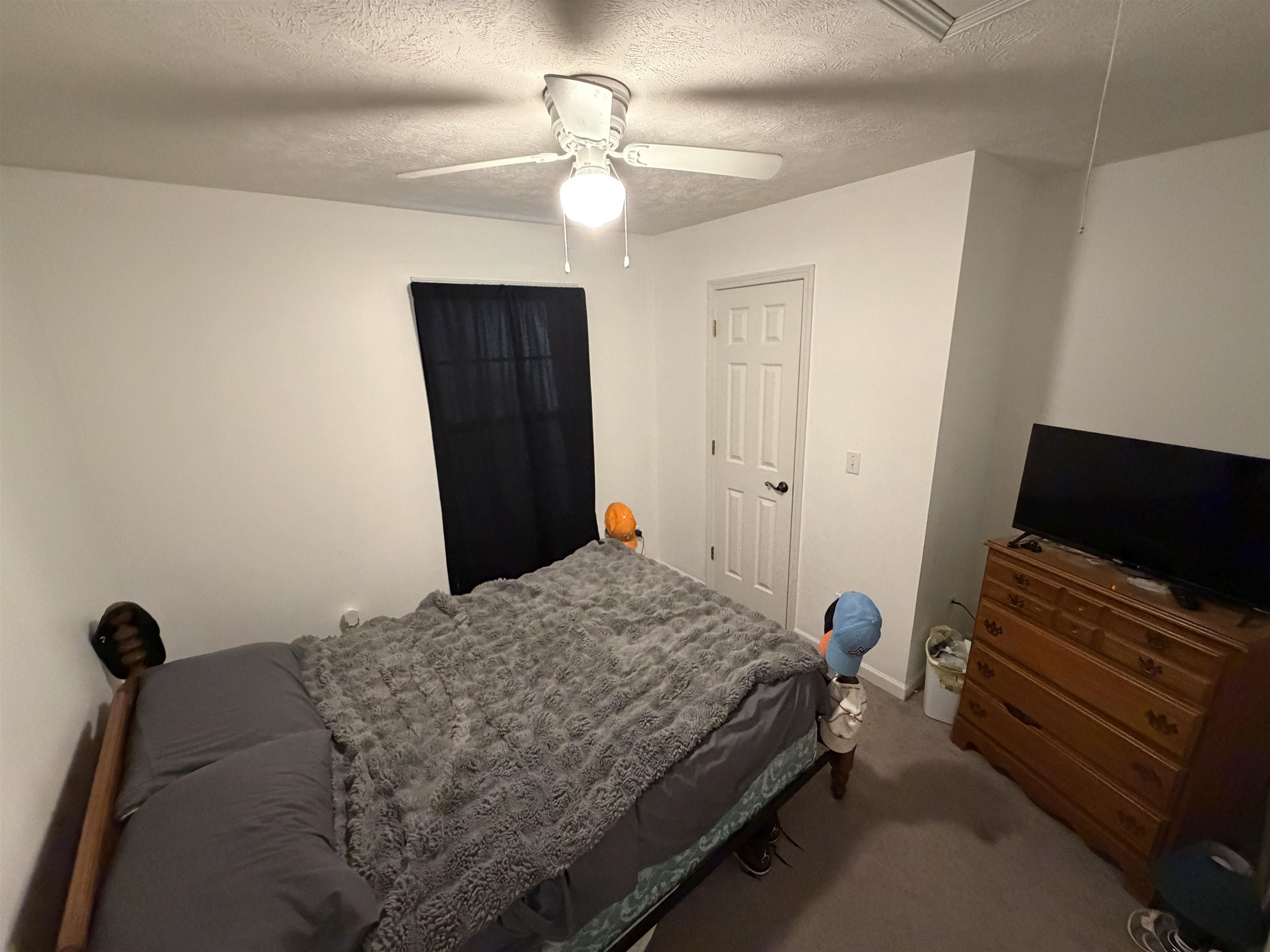 191 Crabtree Road Selmer, TN 38375 - Photo 13 of 18 a bedroom with a bed and a flat tv screen on a dresser