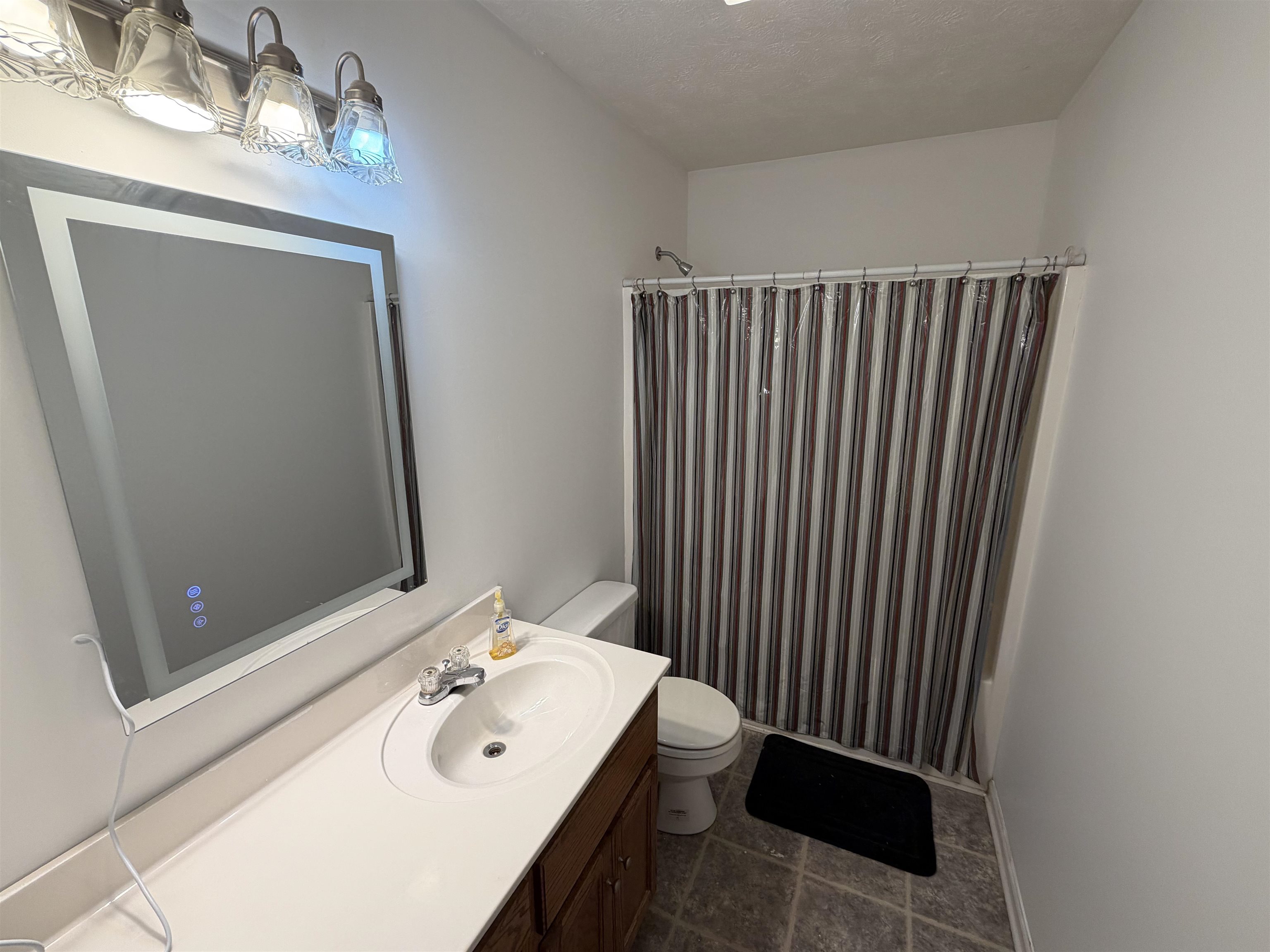 191 Crabtree Road Selmer, TN 38375 - Photo 14 of 18 a bathroom with a sink a toilet and mirror