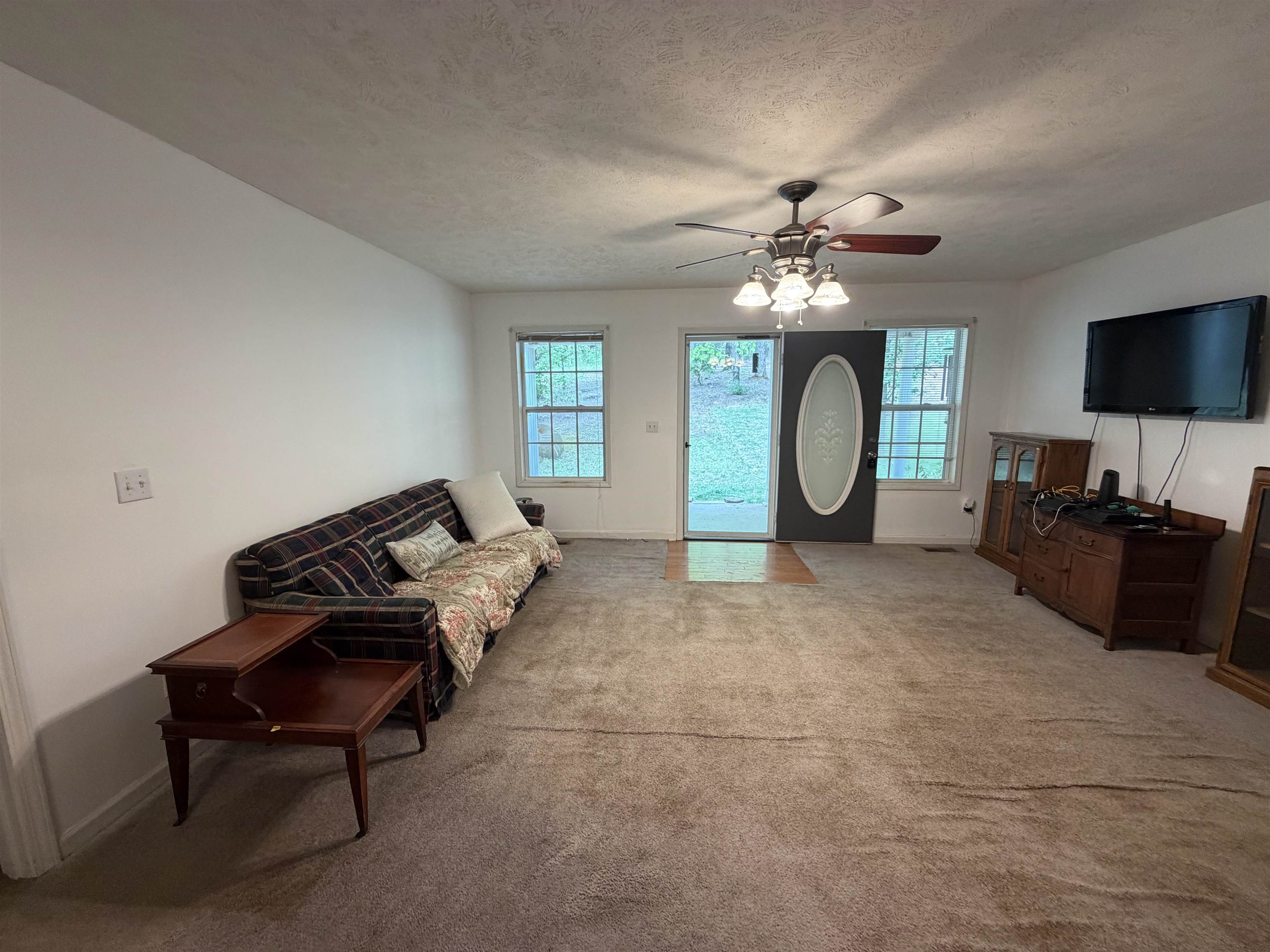 191 Crabtree Road Selmer, TN 38375 - Photo 5 of 18 a living room with furniture a flat screen tv and a window