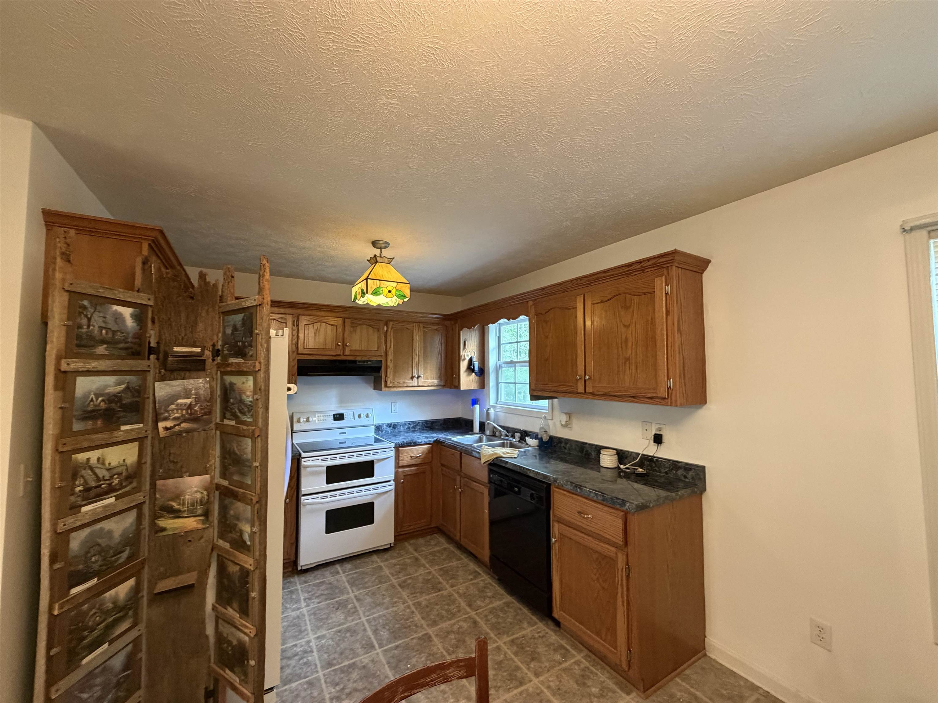 191 Crabtree Road Selmer, TN 38375 - Photo 10 of 18 a kitchen with stainless steel appliances granite countertop a stove a sink and a refrigerator