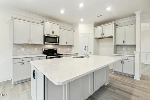 a view of a room with wooden floor fireplace and windows
