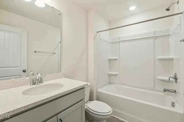 a view of a house with a backyard and a garage