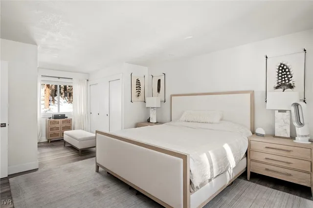 a view of a bedroom from hallway with wooden floor