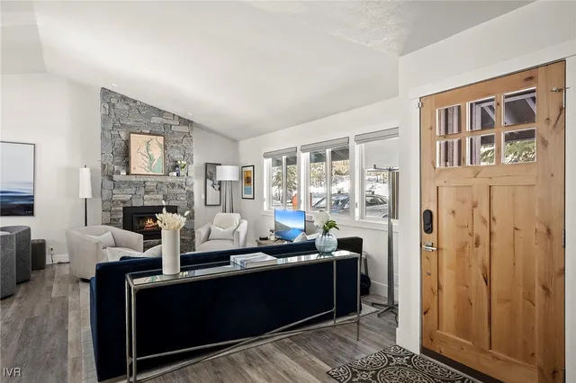 a living room with furniture a fireplace and a flat screen tv