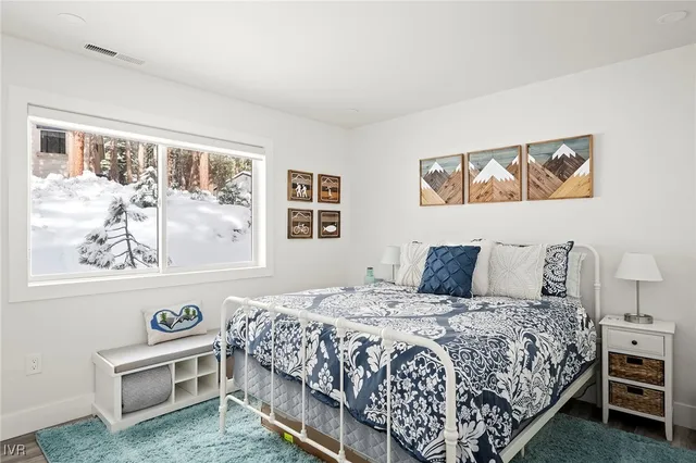 a bedroom with a bed lamp and a window