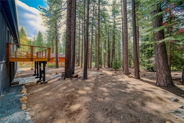 a view of a building with a street sign and a yard