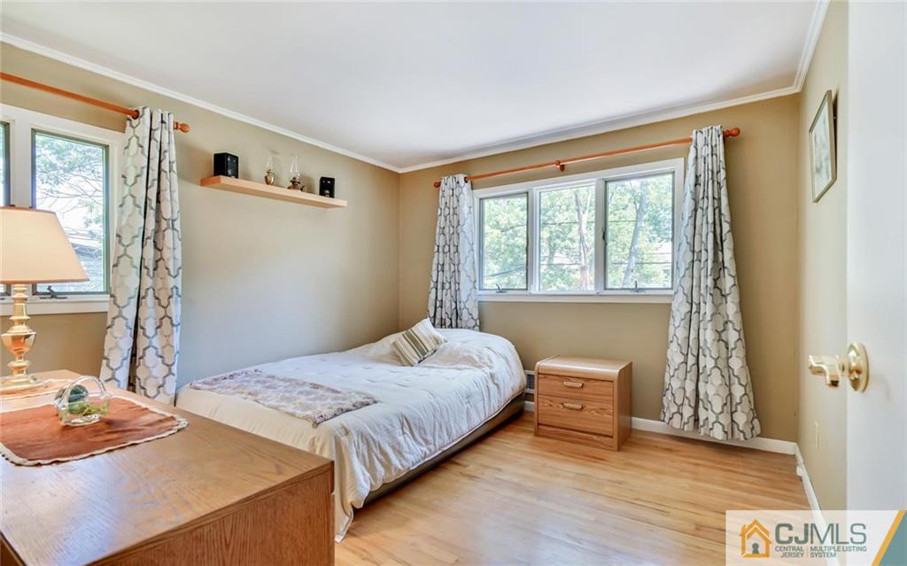 21 Peake Road Edison, NJ 08837 - Photo 14 of 24 a bedroom with a bed and wooden floor
