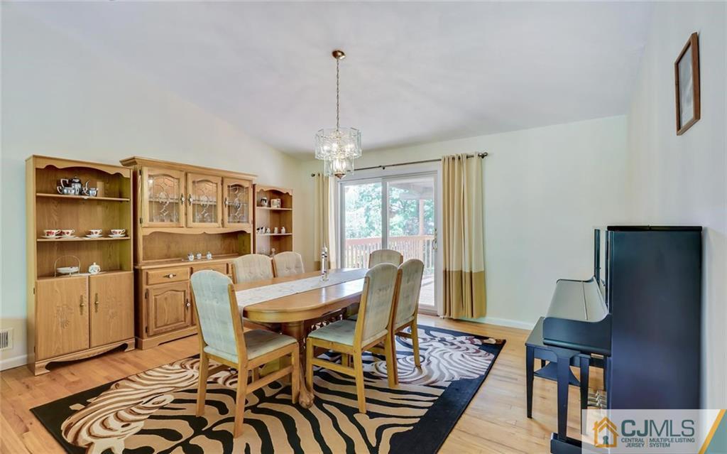 21 Peake Road Edison, NJ 08837 - Photo 8 of 24 a view of a dining room with furniture window and wooden floor