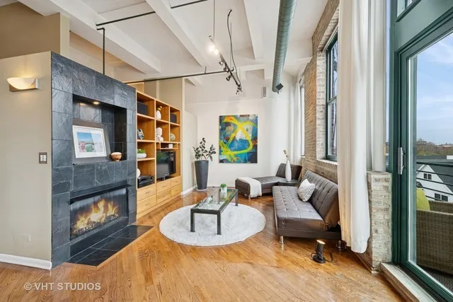 a living room with furniture and a fireplace