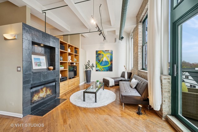 2222 West Diversey Avenue, Unit 407 Chicago, IL 60647 - Photo 11 of 30 a living room with furniture and a fireplace