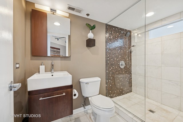 2222 West Diversey Avenue, Unit 407 Chicago, IL 60647 - Photo 17 of 30 a bathroom with a sink toilet and shower