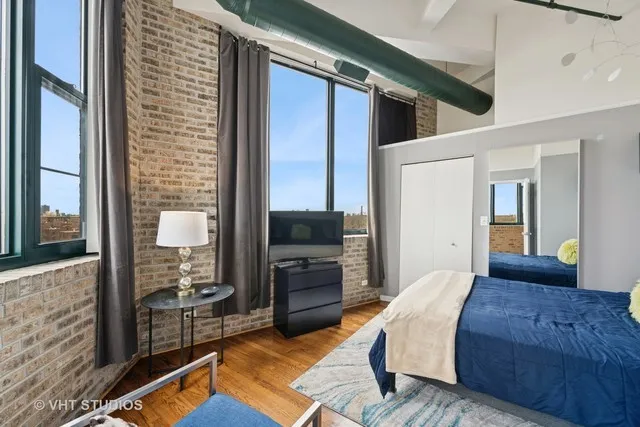 a large bedroom with a bed and glass door