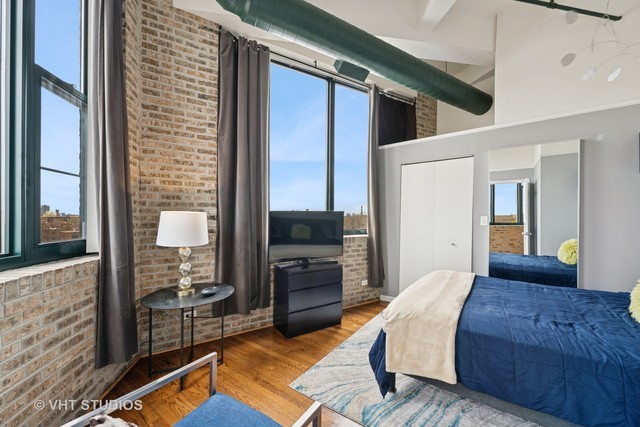 2222 West Diversey Avenue, Unit 407 Chicago, IL 60647 - Photo 18 of 30 a large bedroom with a bed and glass door