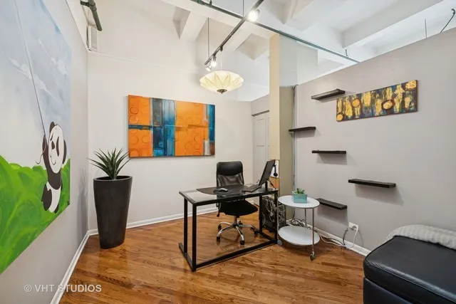 a view of a workspace with furniture and a window