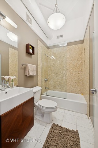 2222 West Diversey Avenue, Unit 407 Chicago, IL 60647 - Photo 21 of 30 a bathroom with a sink a toilet and shower