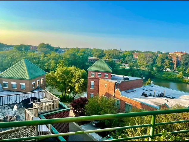 an aerial view of residential houses with outdoor space and trees