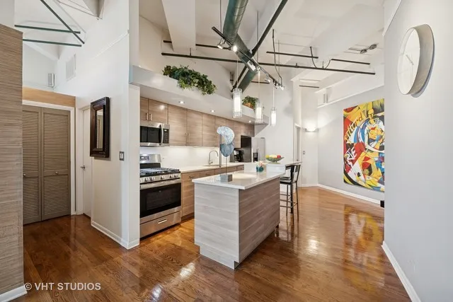 a kitchen with stainless steel appliances granite countertop a stove and a refrigerator