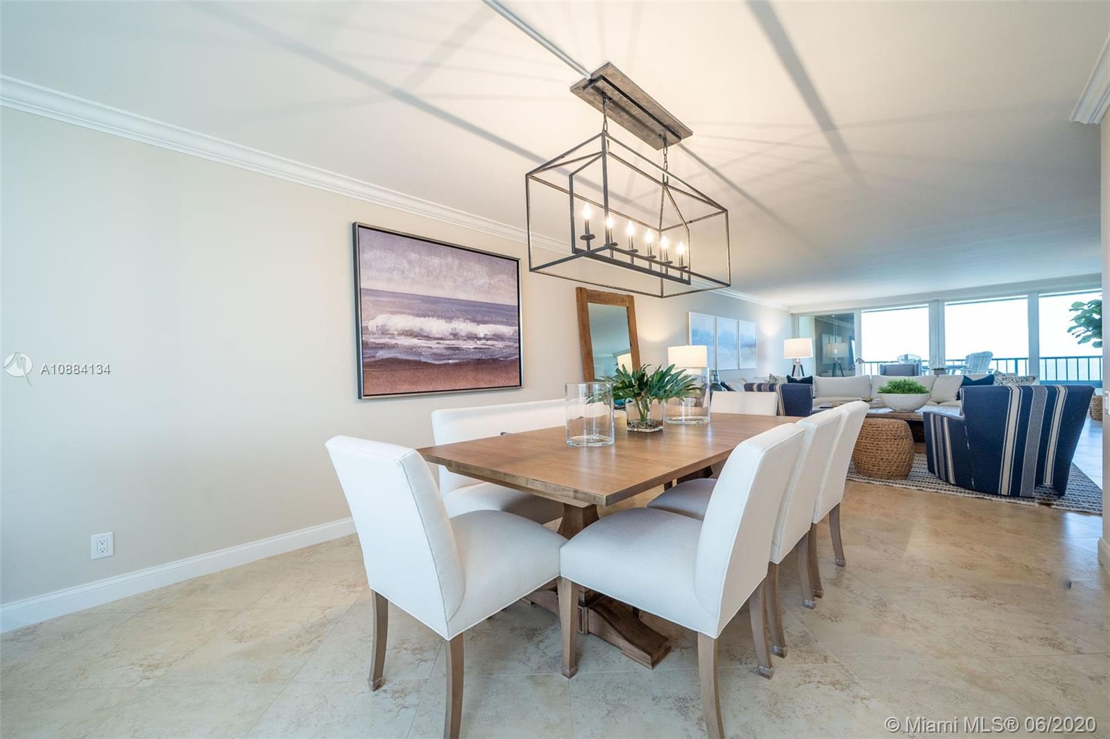 19900 South Beach Road, Unit 803 Jupiter, FL 33469 - Photo 13 of 64 a dining room with furniture a chandelier and window