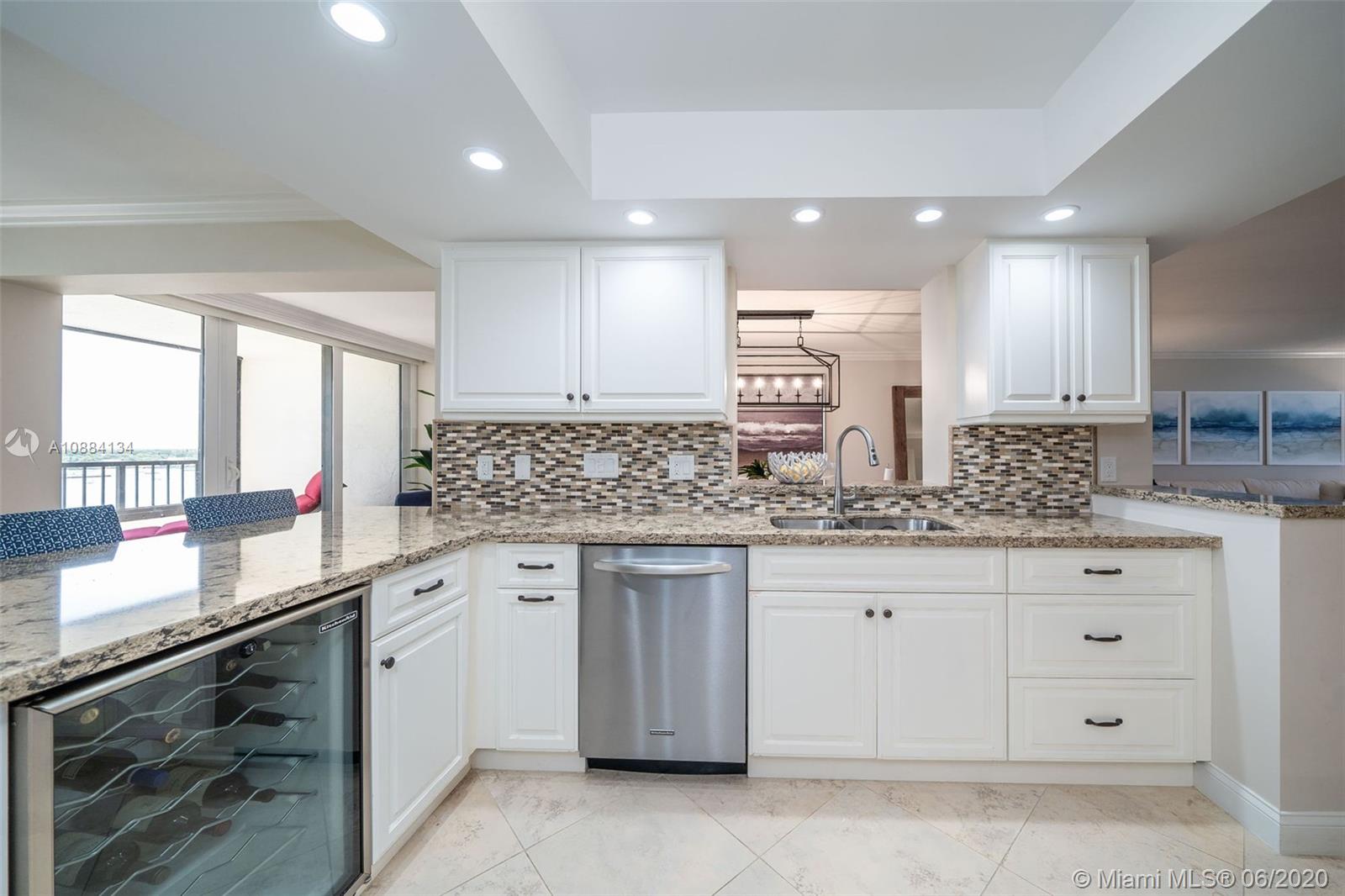 19900 South Beach Road, Unit 803 Jupiter, FL 33469 - Photo 16 of 64 a kitchen with granite countertop white cabinets and white appliances