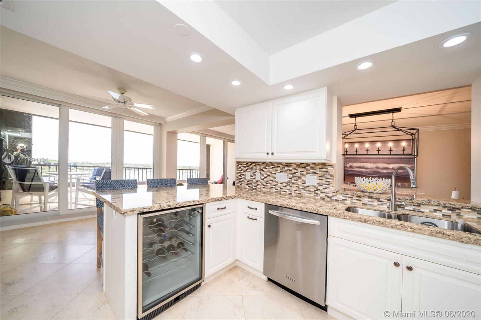 19900 South Beach Road, Unit 803 Jupiter, FL 33469 - Photo 17 of 64 a kitchen with a sink stove and cabinets