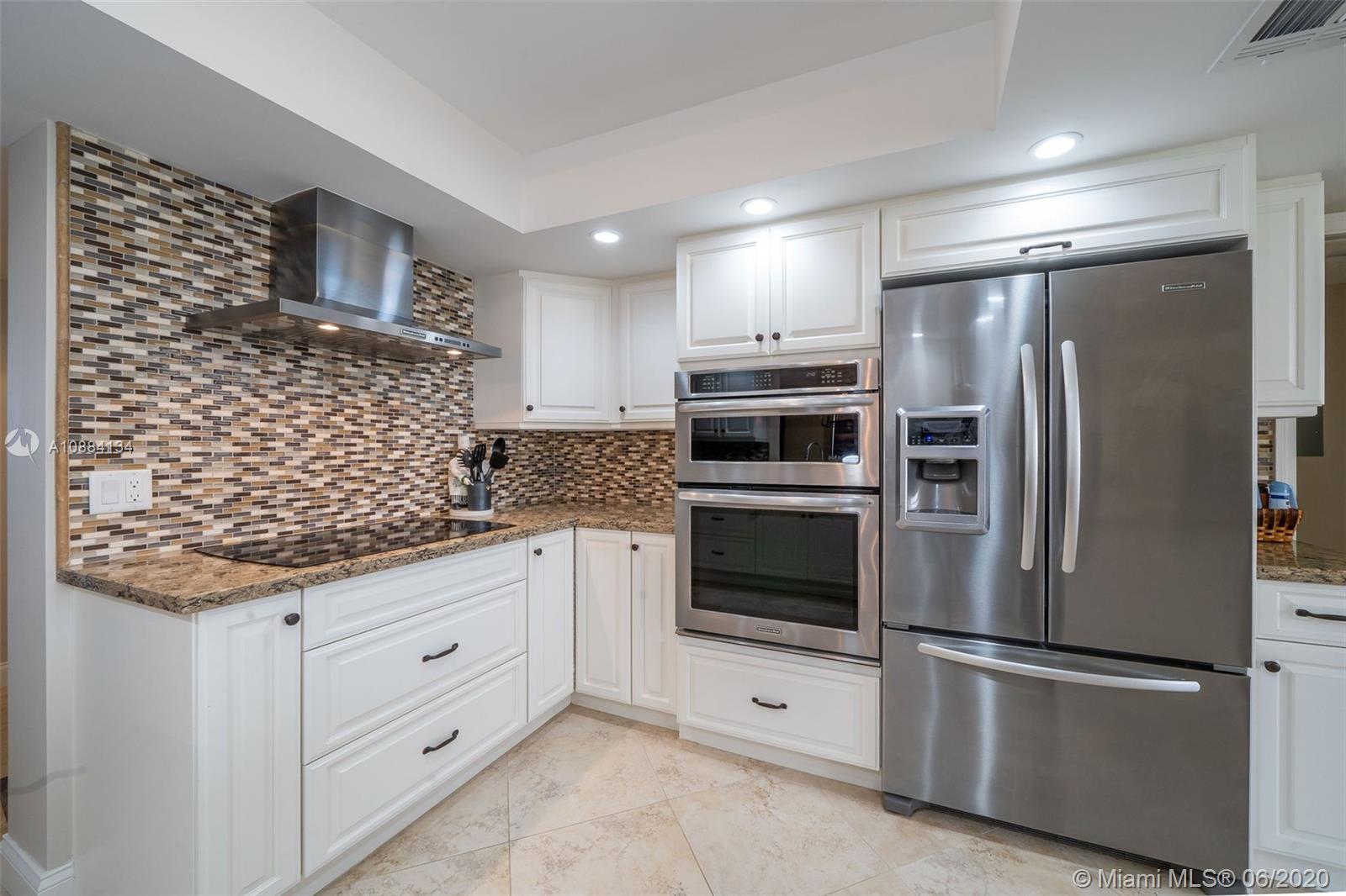 19900 South Beach Road, Unit 803 Jupiter, FL 33469 - Photo 18 of 64 a kitchen with stainless steel appliances granite countertop a refrigerator sink and cabinets