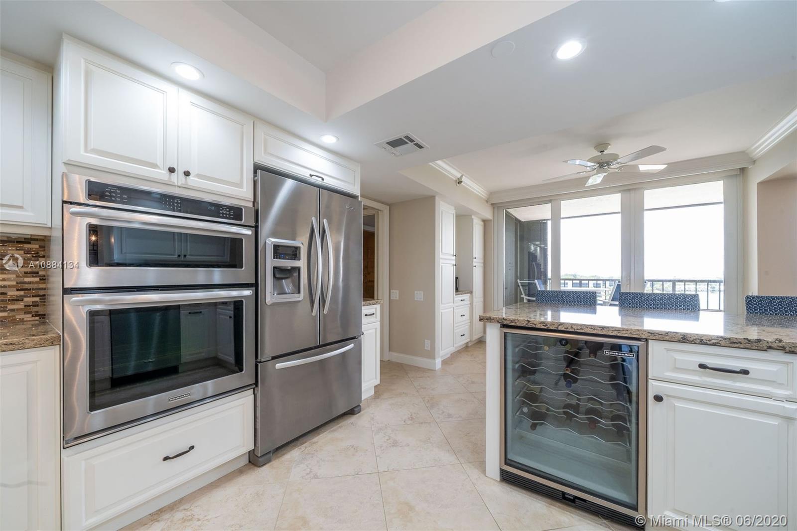 19900 South Beach Road, Unit 803 Jupiter, FL 33469 - Photo 19 of 64 a kitchen with stainless steel appliances granite countertop a refrigerator and a stove top oven