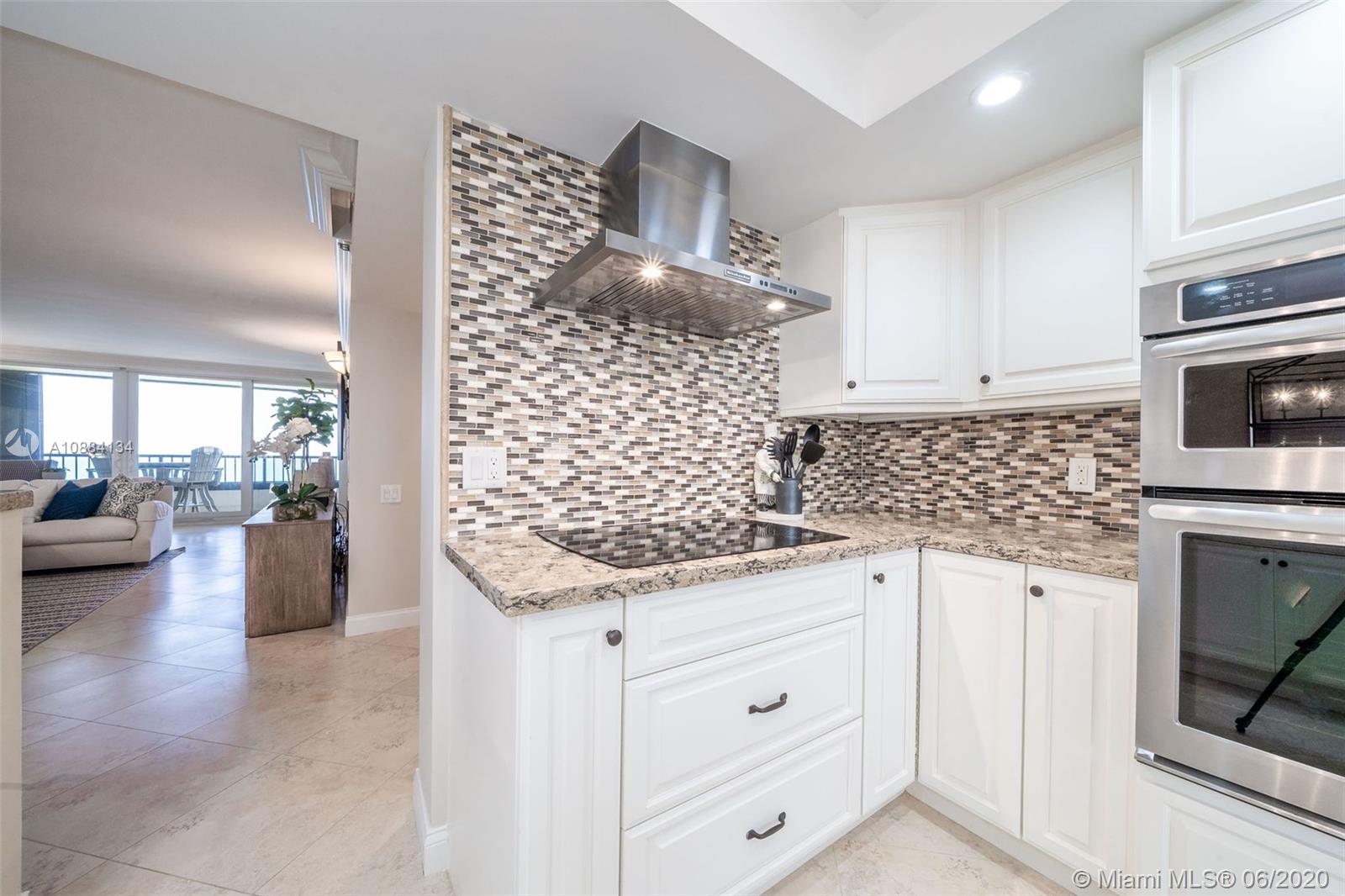 19900 South Beach Road, Unit 803 Jupiter, FL 33469 - Photo 20 of 64 a kitchen with granite countertop white cabinets and stainless steel appliances