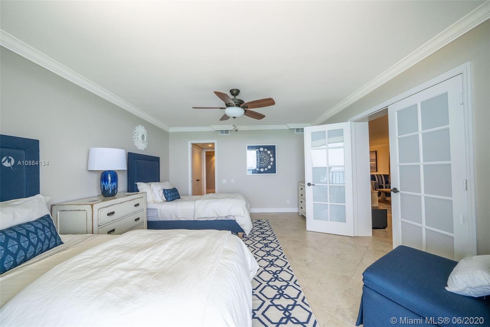 19900 South Beach Road, Unit 803 Jupiter, FL 33469 - Photo 26 of 64 a spacious bedroom with a bed and a desk