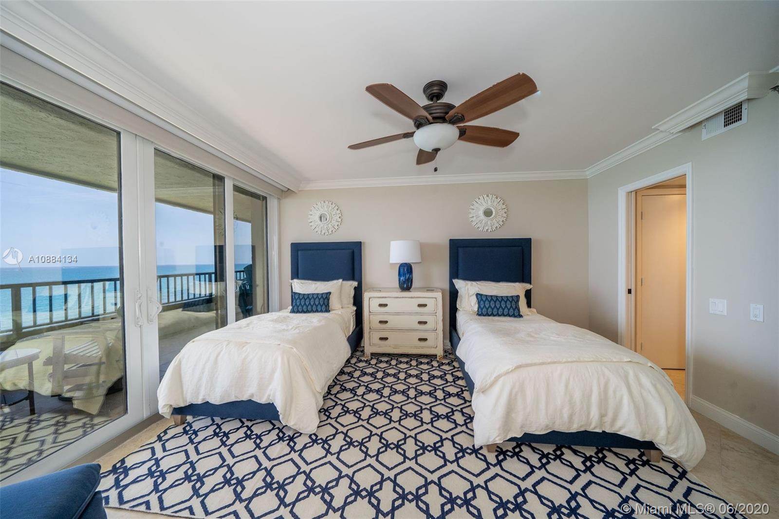 19900 South Beach Road, Unit 803 Jupiter, FL 33469 - Photo 29 of 64 a bedroom with a large bed and a large window
