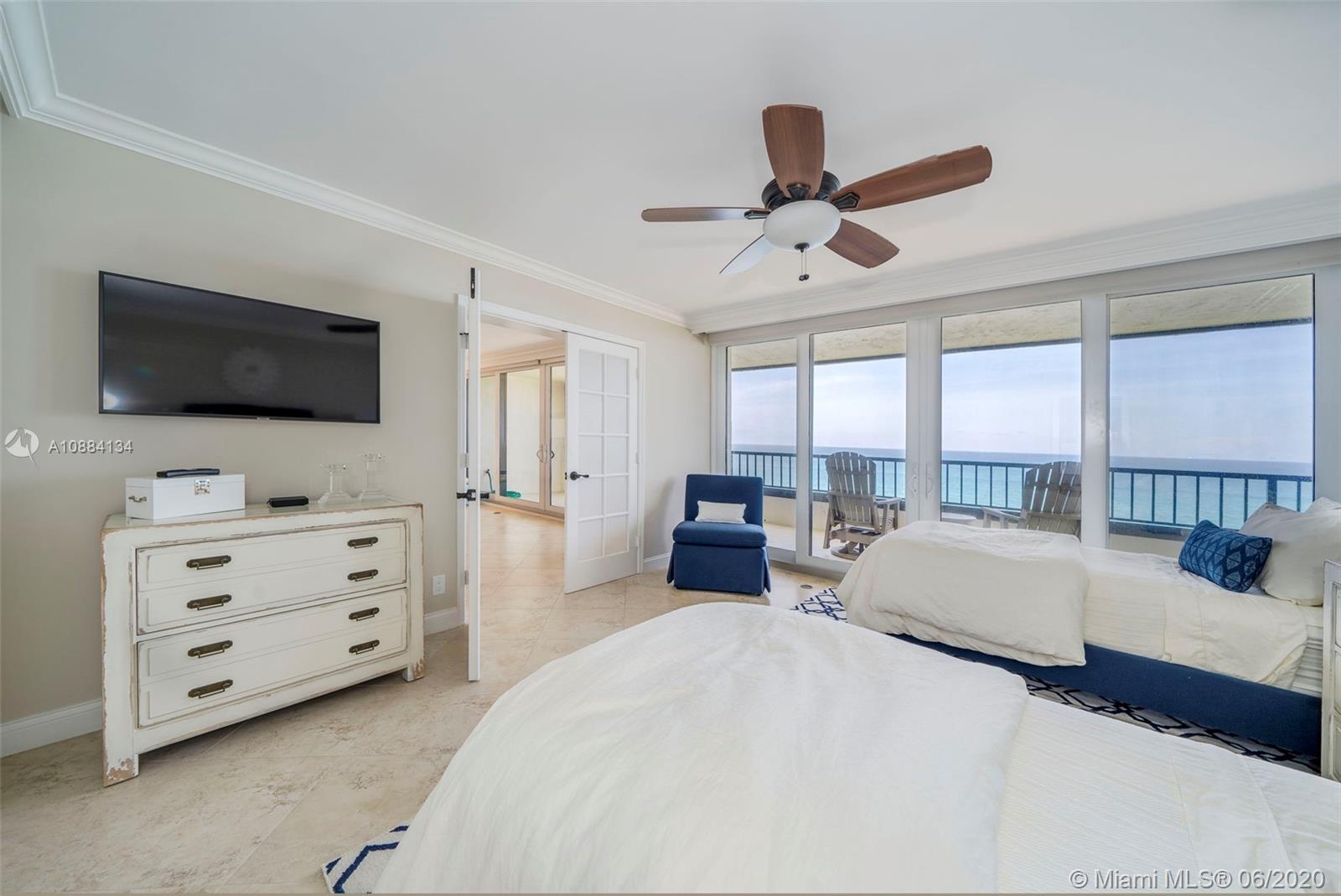 19900 South Beach Road, Unit 803 Jupiter, FL 33469 - Photo 32 of 64 a bedroom with furniture and a flat screen tv