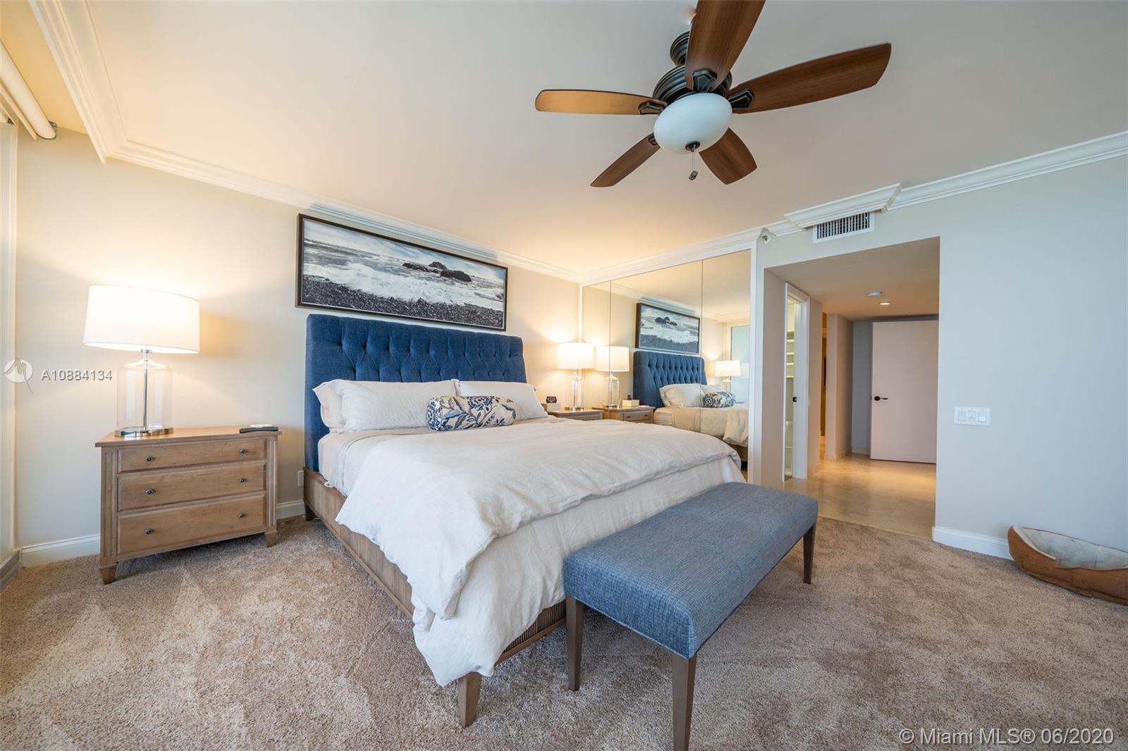 19900 South Beach Road, Unit 803 Jupiter, FL 33469 - Photo 35 of 64 a bed room with a bed and a chandelier