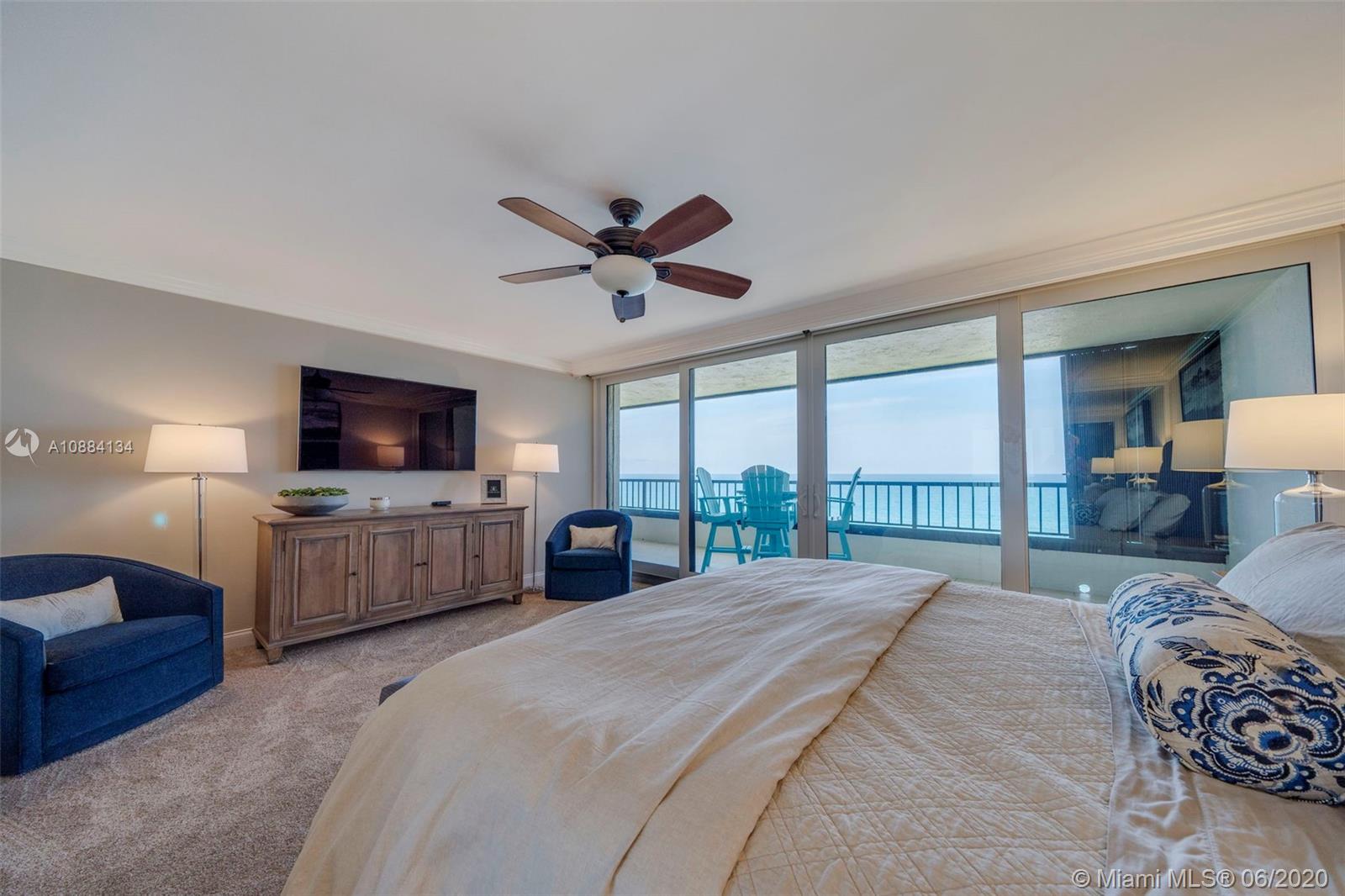 19900 South Beach Road, Unit 803 Jupiter, FL 33469 - Photo 38 of 64 a bedroom with a large bed a flat screen tv and a couch