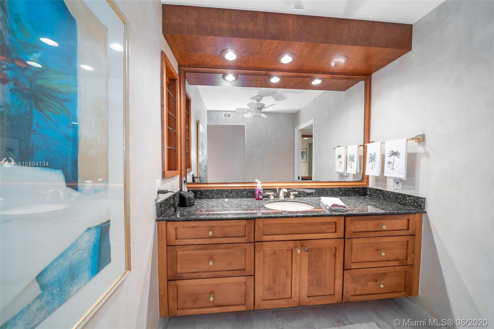 19900 South Beach Road, Unit 803 Jupiter, FL 33469 - Photo 40 of 64 a bathroom with a granite countertop sink and a mirror