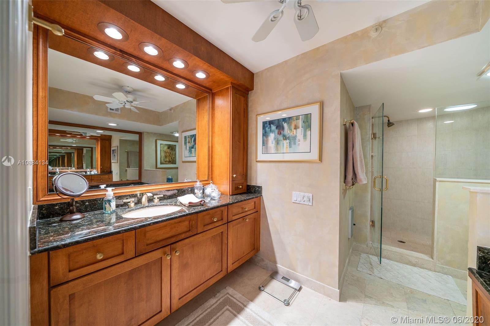 19900 South Beach Road, Unit 803 Jupiter, FL 33469 - Photo 41 of 64 a bathroom with a granite countertop sink mirror and shower