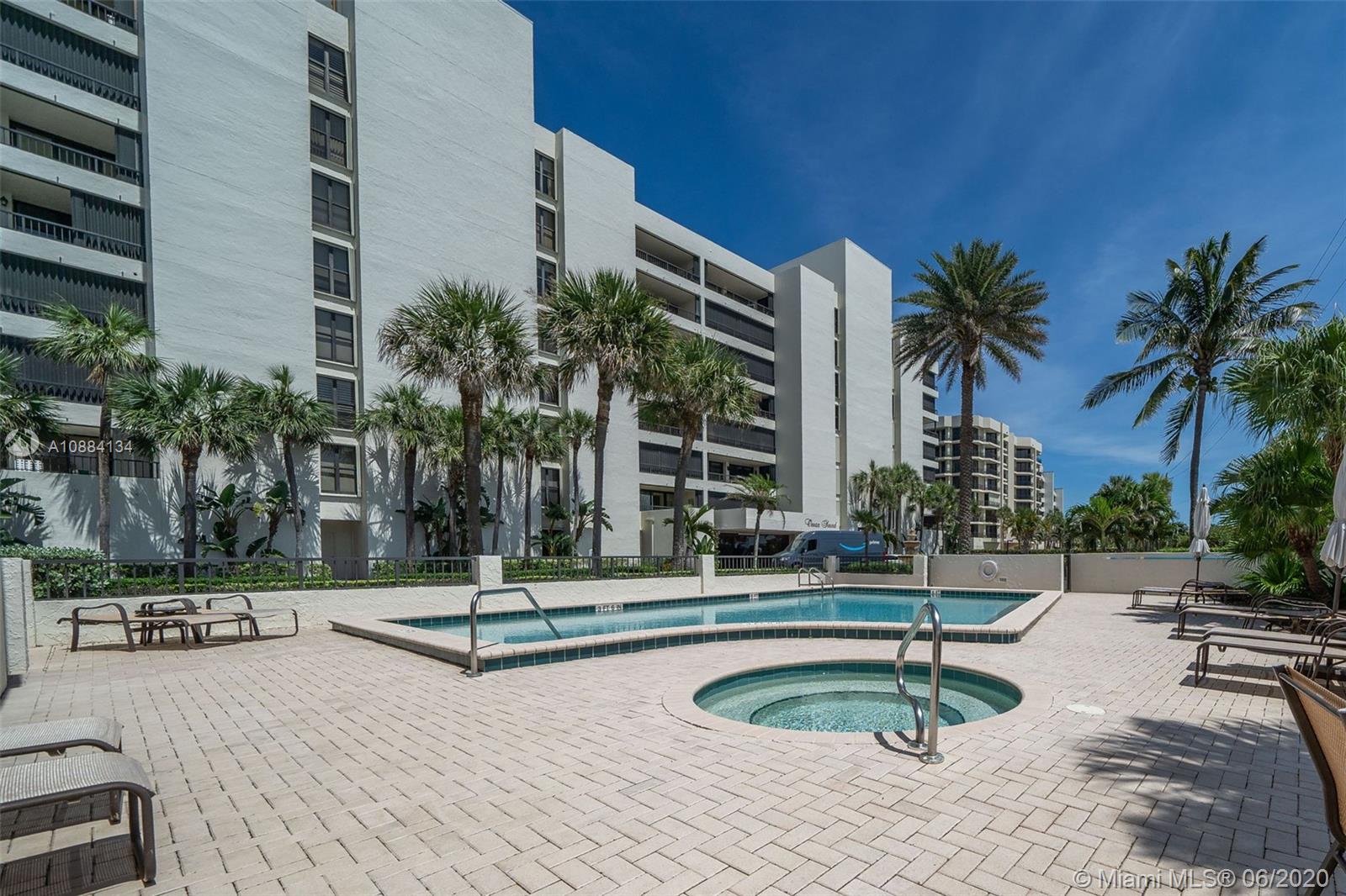 19900 South Beach Road, Unit 803 Jupiter, FL 33469 - Photo 59 of 64 a building with palm trees and a sign board