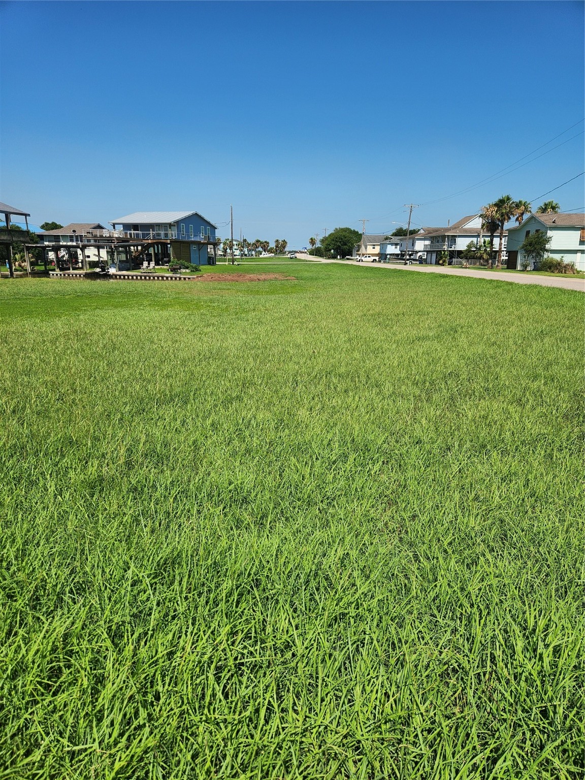 0 Treasure Lane Freeport, TX 77541 - Photo 2 of 7 a view of a green field with clear sky