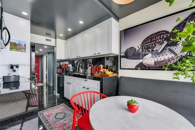 a kitchen with stainless steel appliances kitchen island granite countertop a refrigerator a stove and a sink