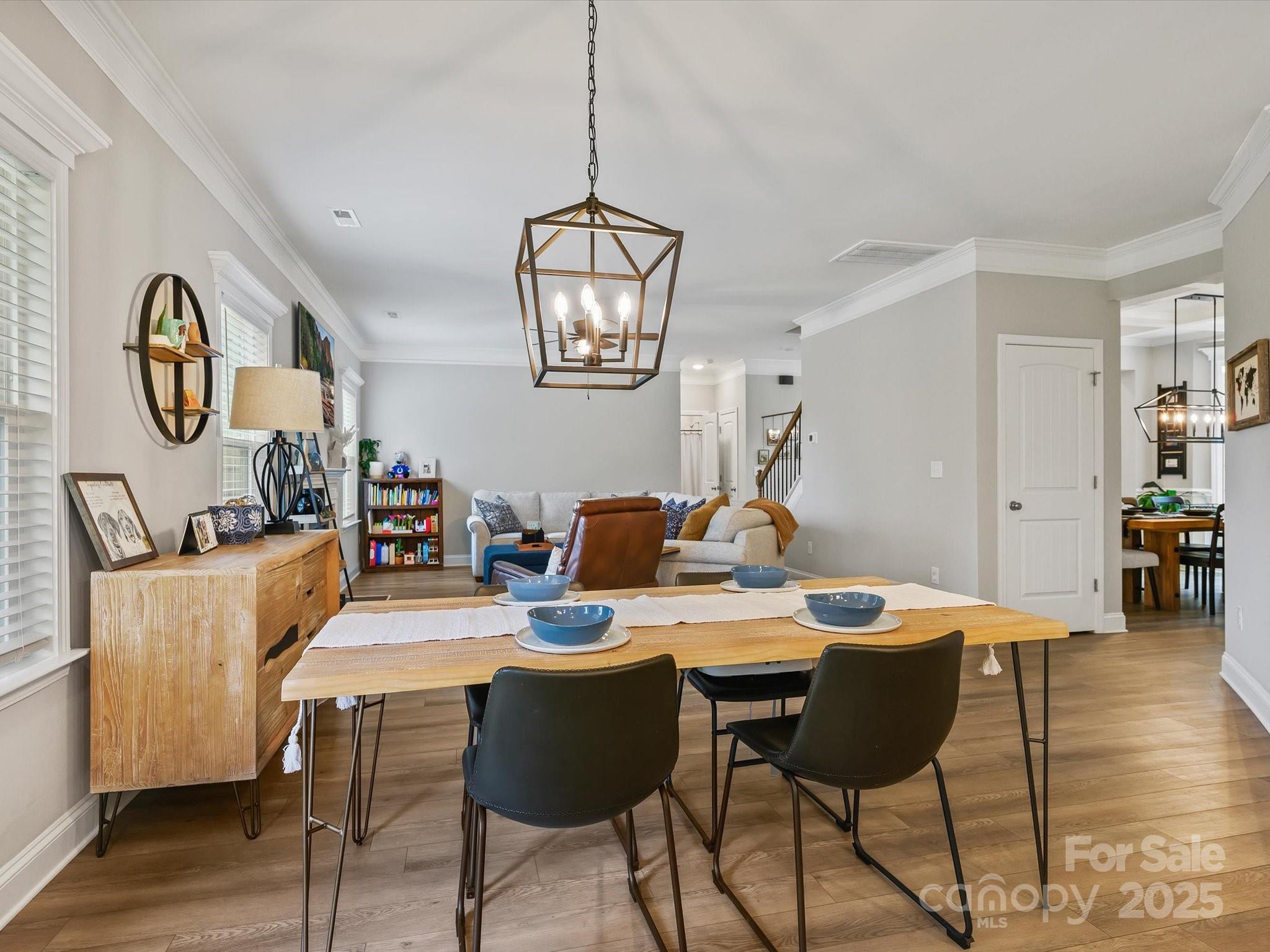 2901 South Point Road Belmont, NC 28012 - Photo 14 of 35 a view of a dining room with furniture wooden floor and a chandelier
