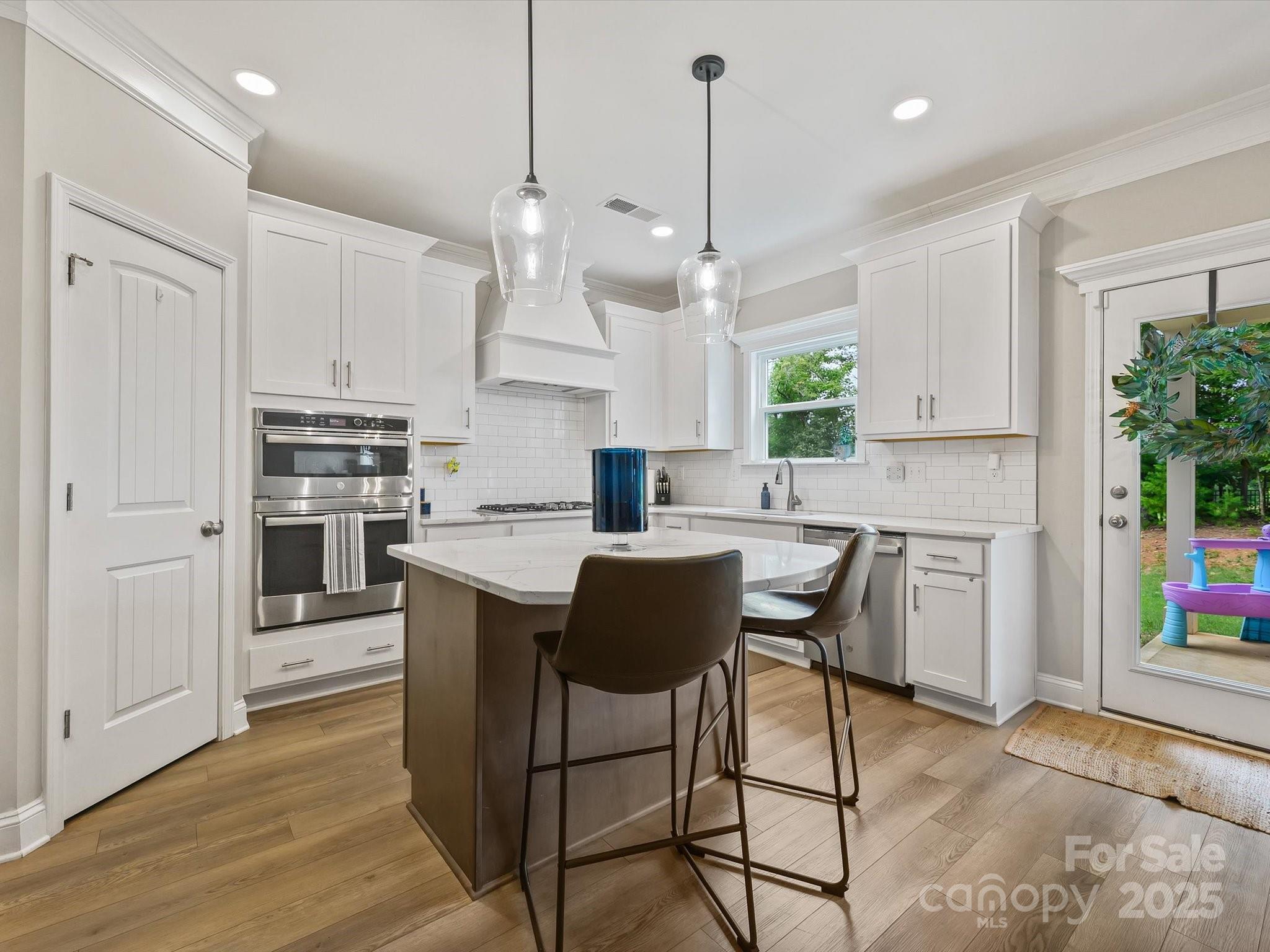 2901 South Point Road Belmont, NC 28012 - Photo 16 of 35 a kitchen with kitchen island granite countertop a counter space dining table and stainless steel appliances