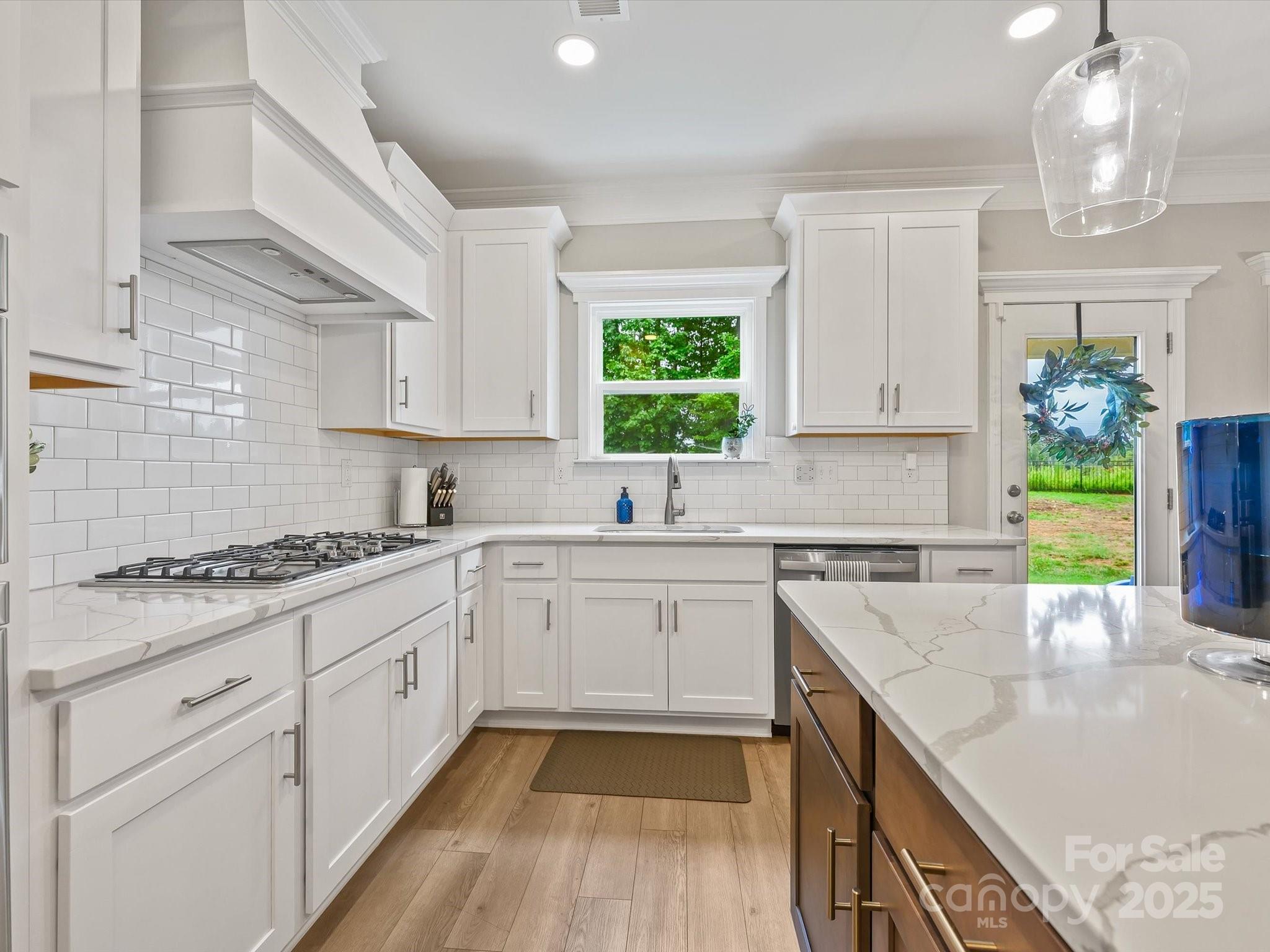 2901 South Point Road Belmont, NC 28012 - Photo 17 of 35 a kitchen with a sink stove and cabinets