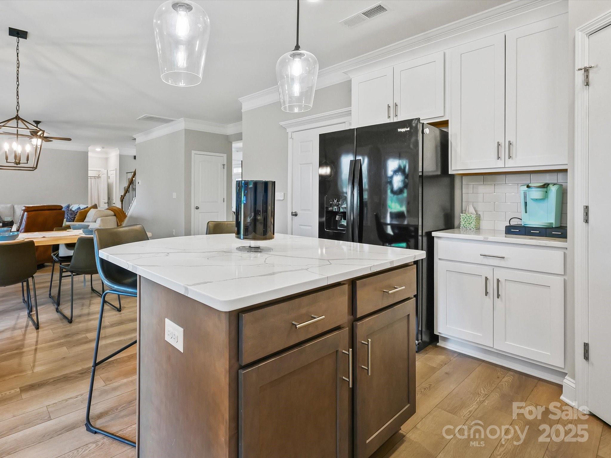 2901 South Point Road Belmont, NC 28012 - Photo 18 of 35 a kitchen with a sink a refrigerator and chandelier