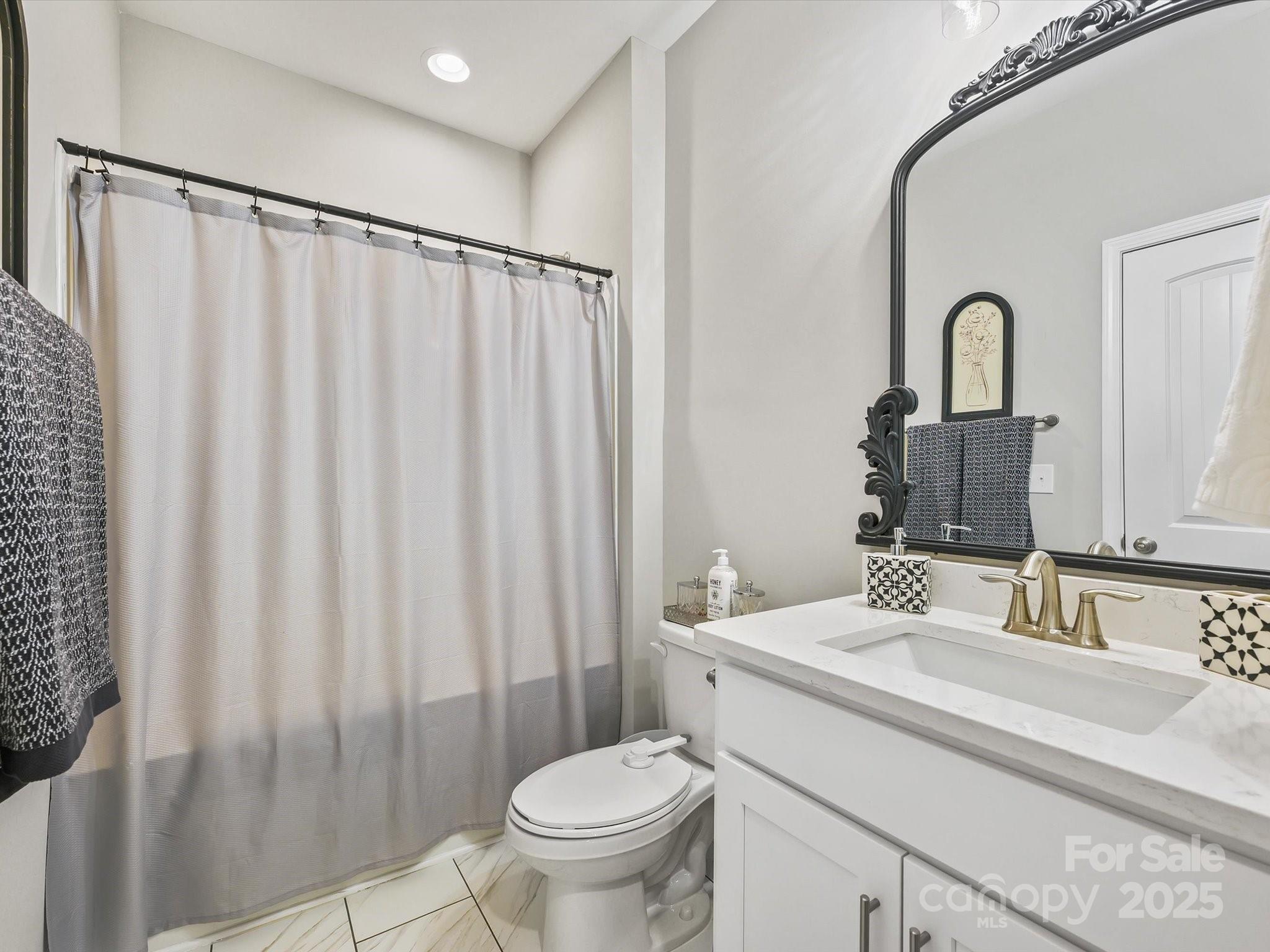 2901 South Point Road Belmont, NC 28012 - Photo 20 of 35 a bathroom with a sink a toilet and a mirror