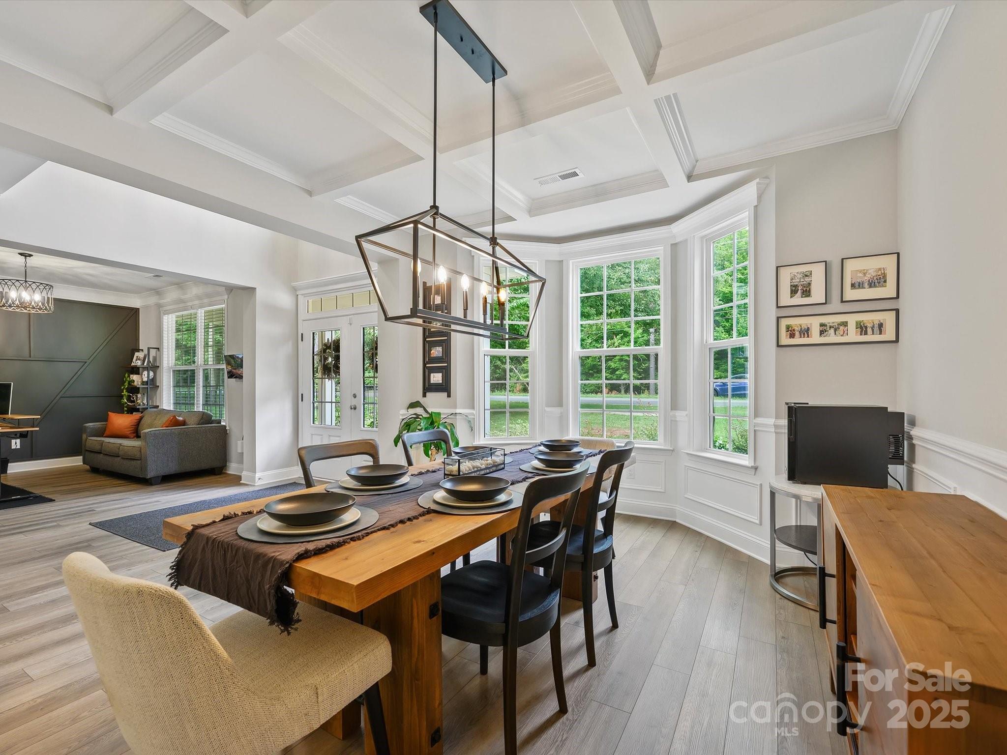 2901 South Point Road Belmont, NC 28012 - Photo 7 of 35 a dining room with furniture a chandelier and wooden floor