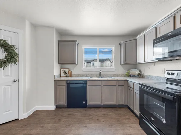a kitchen with stainless steel appliances granite countertop a sink and stove top oven