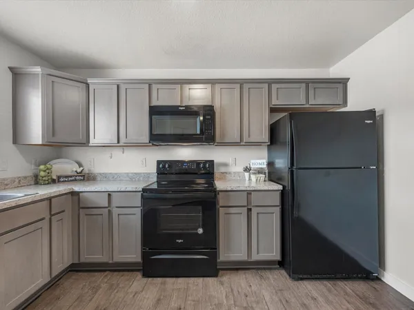 a kitchen with a refrigerator stove and microwave