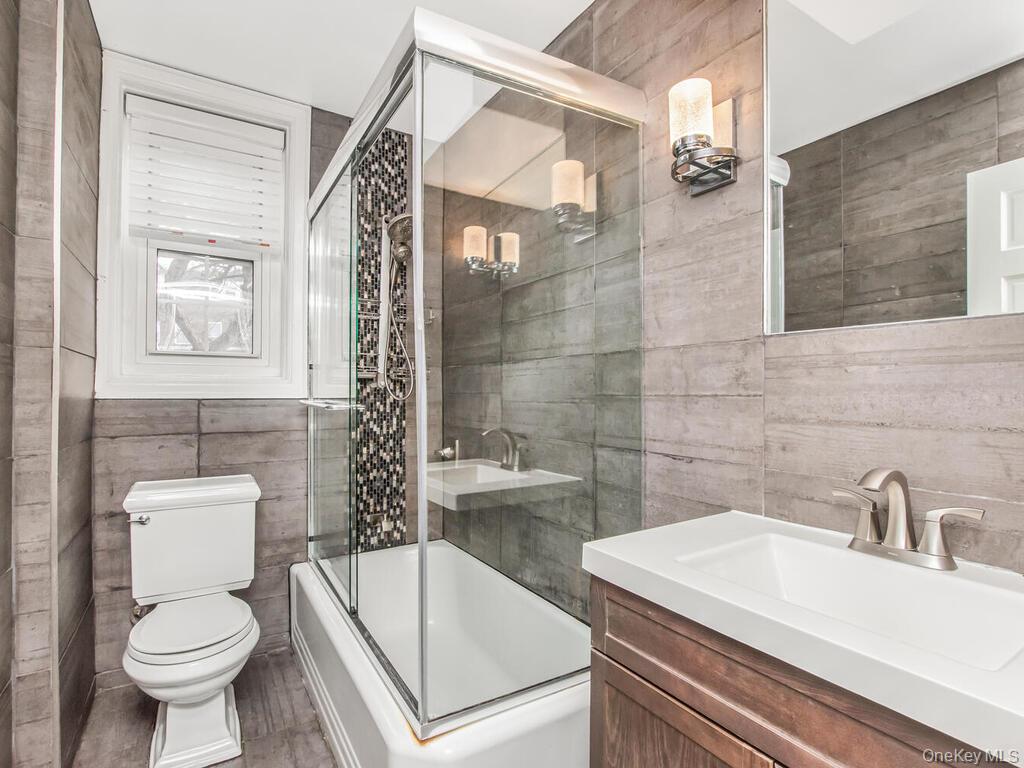 1332 Midland Avenue, Unit 3F Bronxville, NY 10708 - Photo 13 of 21 a bathroom with a sink a toilet and shower