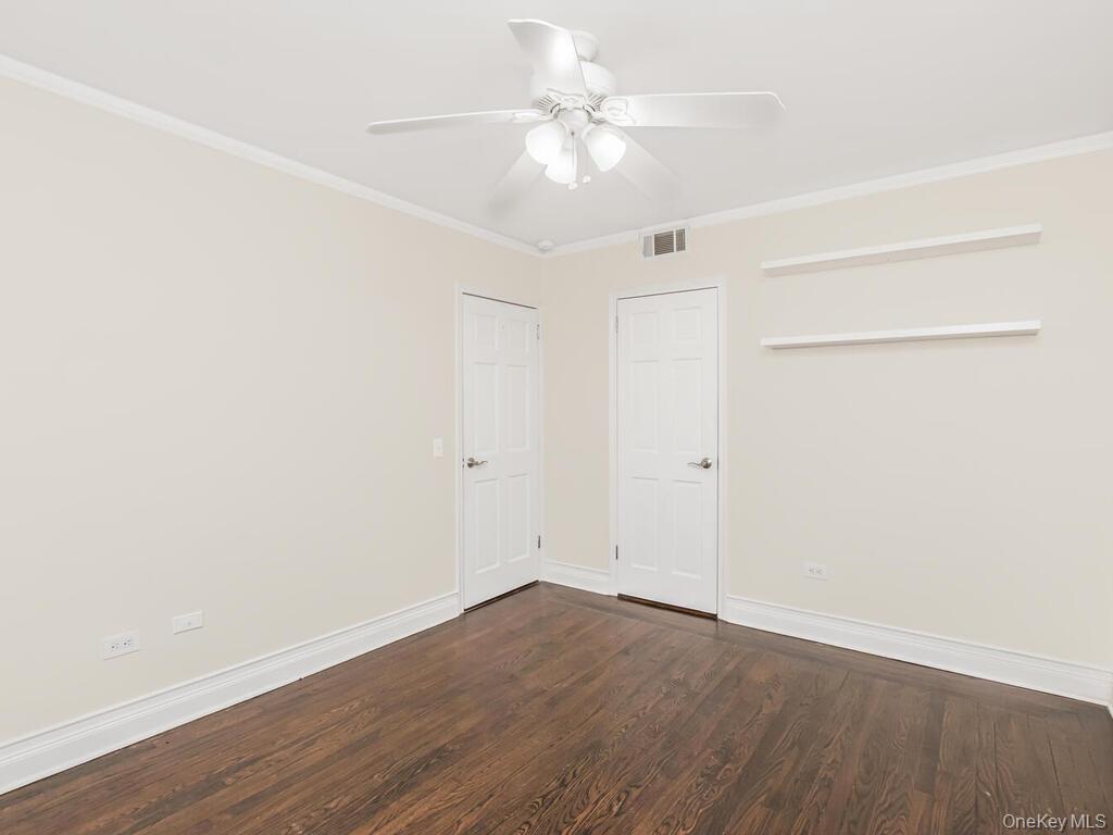 1332 Midland Avenue, Unit 3F Bronxville, NY 10708 - Photo 15 of 21 an empty room with wooden floor and a ceiling fan