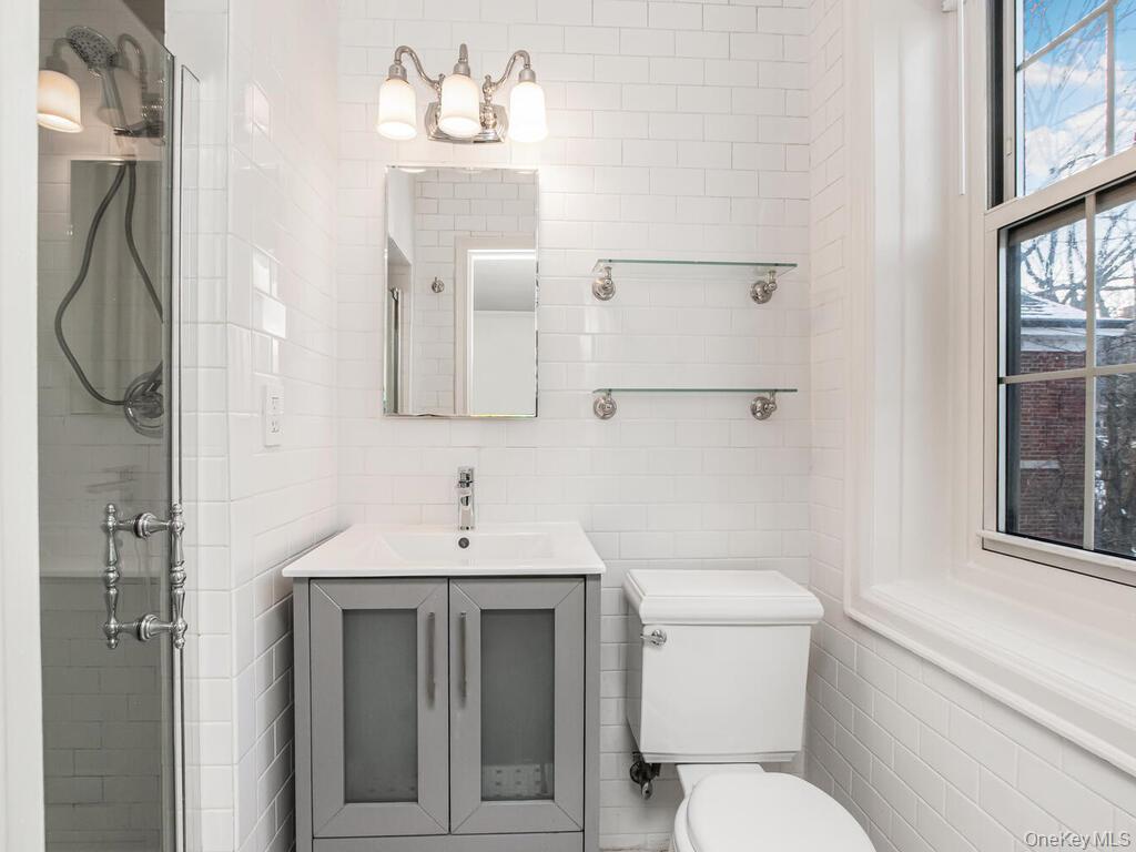 1332 Midland Avenue, Unit 3F Bronxville, NY 10708 - Photo 18 of 21 a bathroom with a toilet sink and mirror