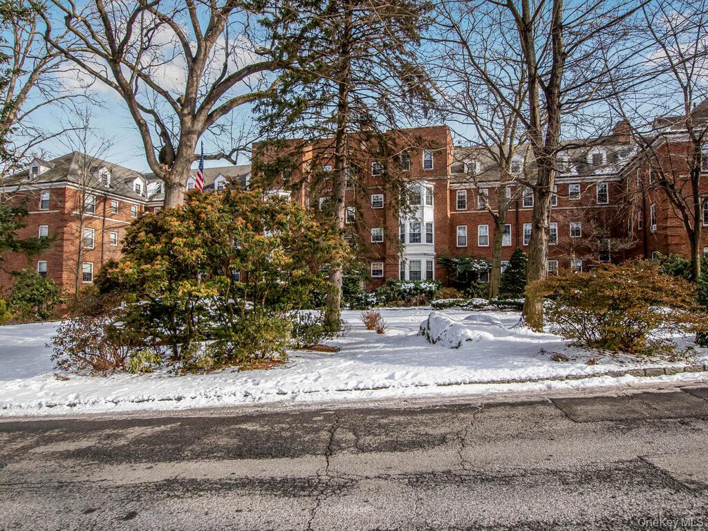 1332 Midland Avenue, Unit 3F Bronxville, NY 10708 - Photo 19 of 21 a view of white house with a yard and trees