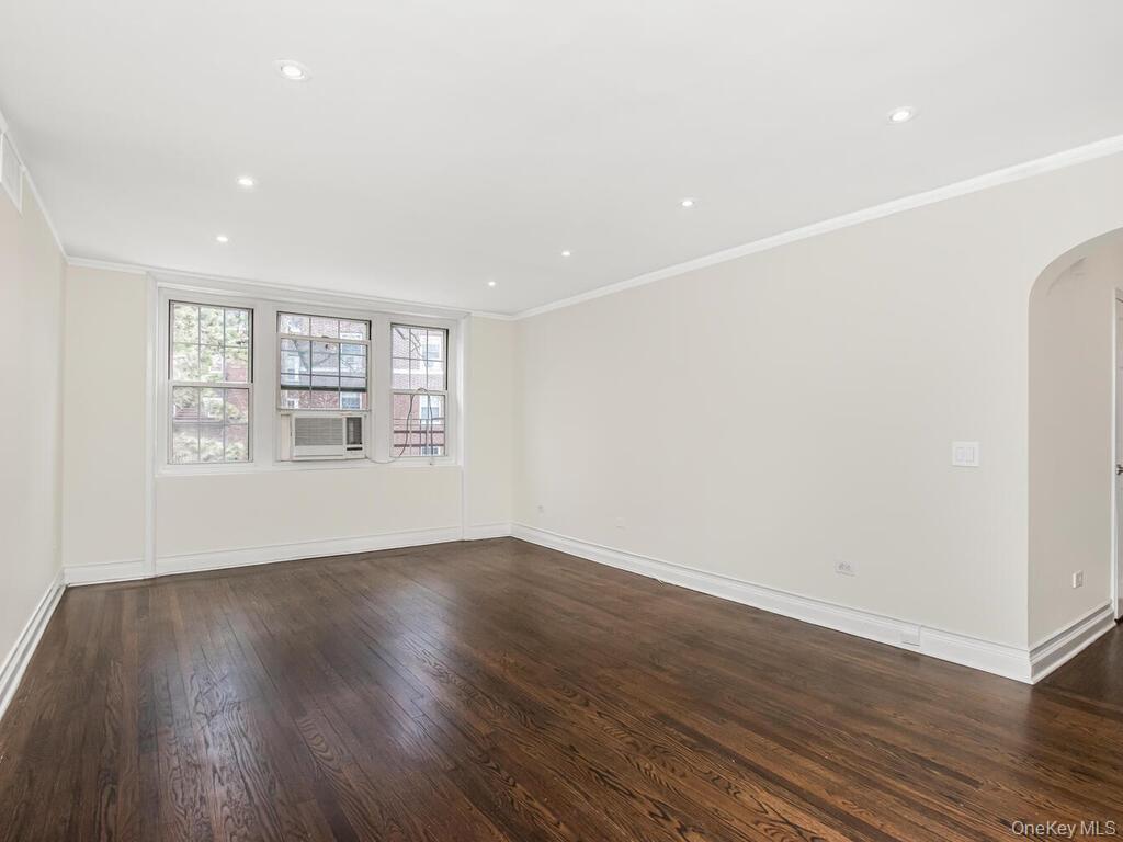 1332 Midland Avenue, Unit 3F Bronxville, NY 10708 - Photo 5 of 21 a view of an empty room with wooden floor and a window